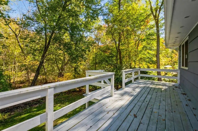 a view of balcony with wooden floor and fence