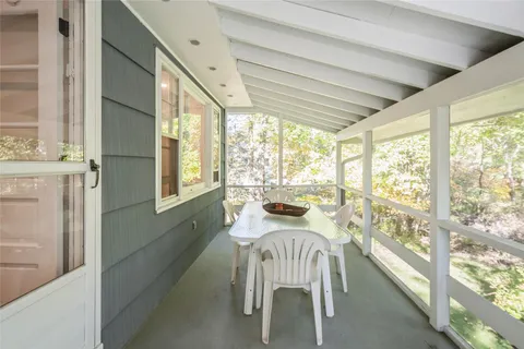 a view of a large dining room with furniture window and outside view
