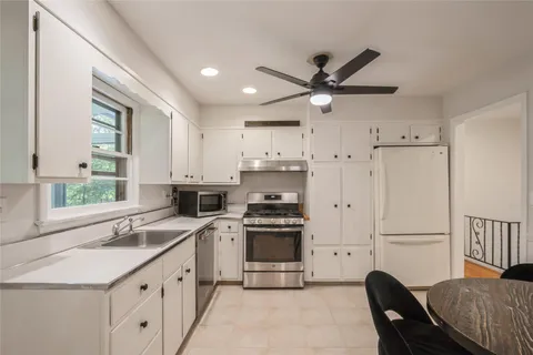 a kitchen with a stove a sink and a refrigerator