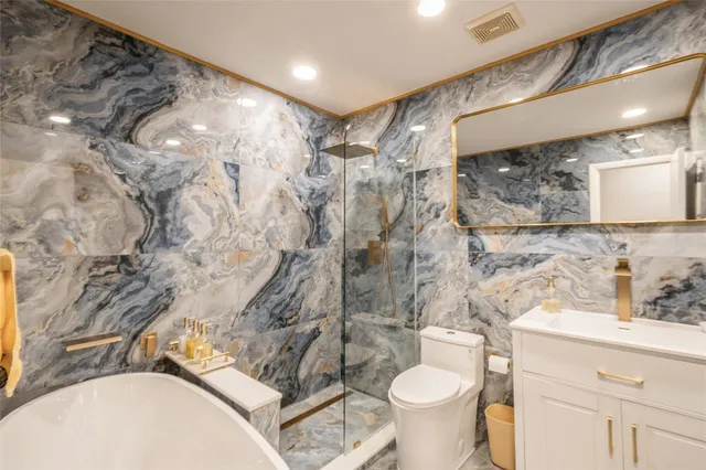 a bathroom with a sink toilet and shower