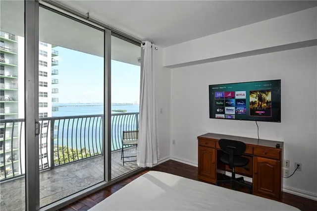 a bedroom with a bed and a flat screen tv