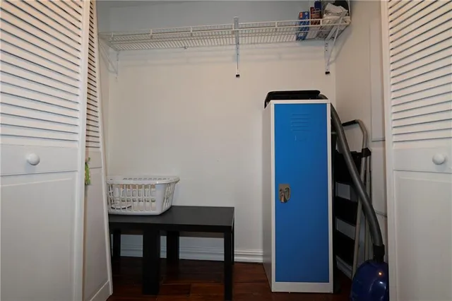 a view of storage and utility room with wooden floor