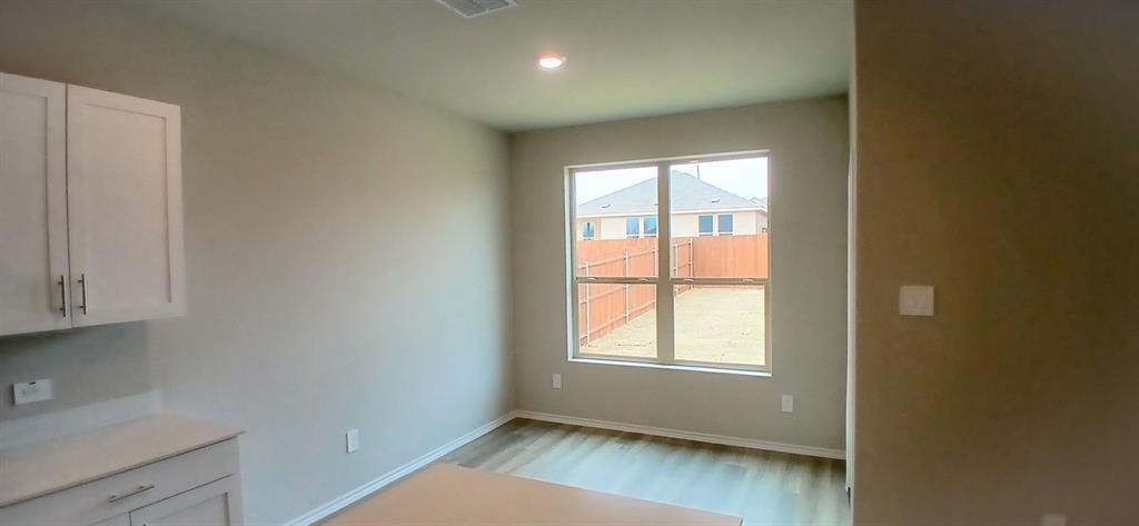 312 Perk Street Keene, TX 76059 - Photo 1 of 13 an empty room with wooden floor and windows