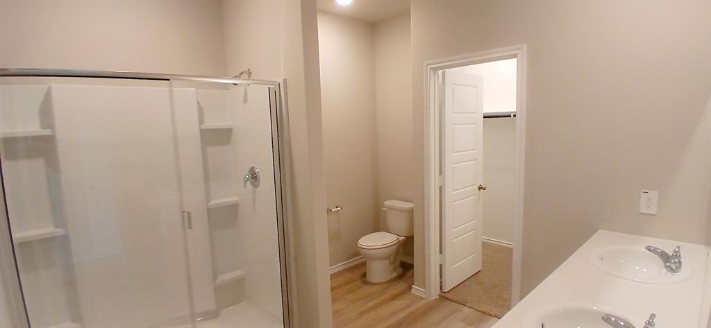 312 Perk Street Keene, TX 76059 - Photo 4 of 13 a bathroom with a shower and a toilet