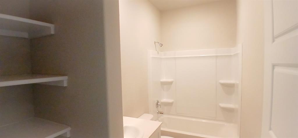 312 Perk Street Keene, TX 76059 - Photo 7 of 13 a bathroom with a bathtub