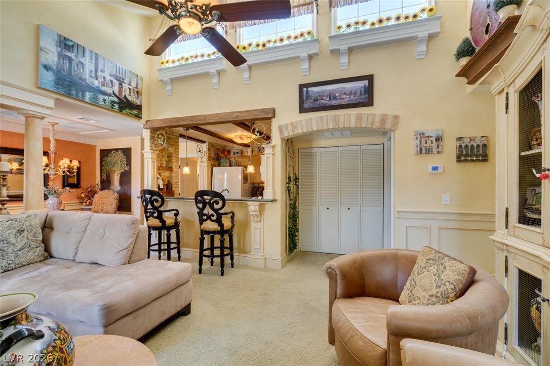 9325 West Desert Inn Road, Unit 244 Las Vegas, NV 89117 - Photo 11 of 55 An inviting gathering space features an elegant wet bar and soaring ceilings.