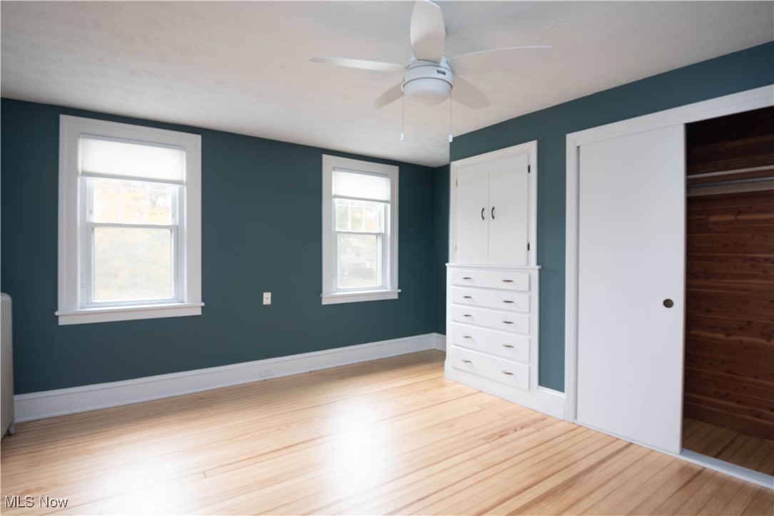 7003 Brecksville Road Independence, OH 44131 - Photo 11 of 35 Unfurnished bedroom with light wood-style flooring, a ceiling fan, and a closet