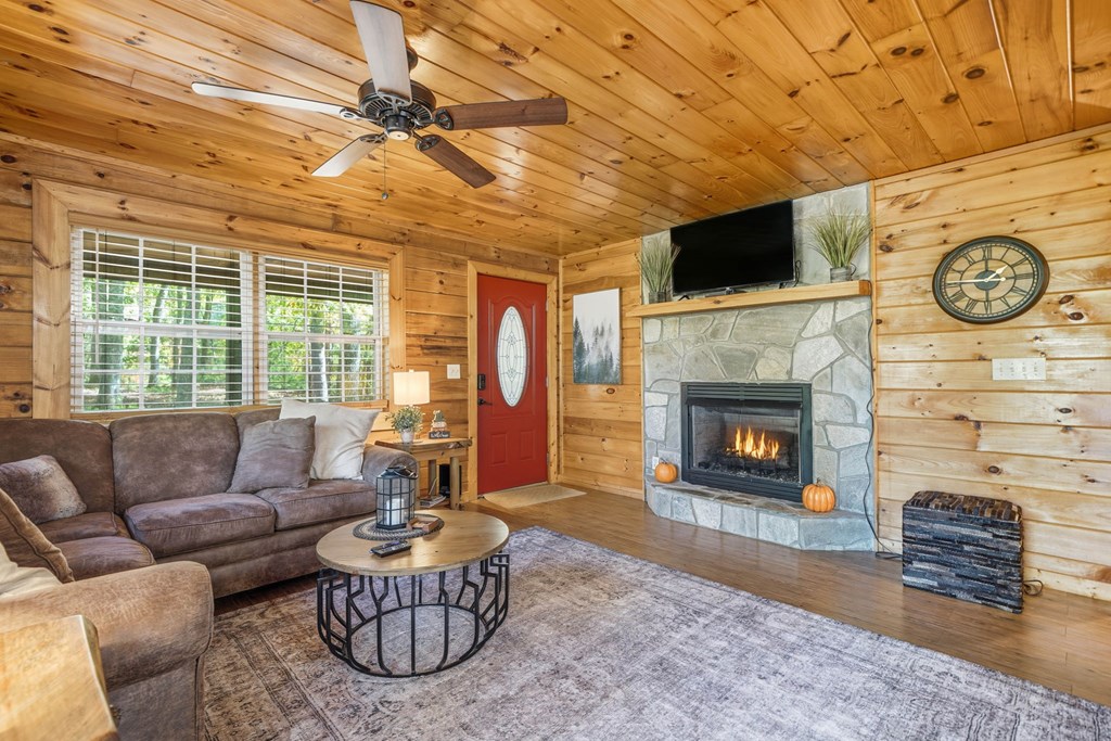 25 Foster Lane Morganton, GA 30560 - Photo 13 of 28 a living room with furniture a flat screen tv and a fireplace