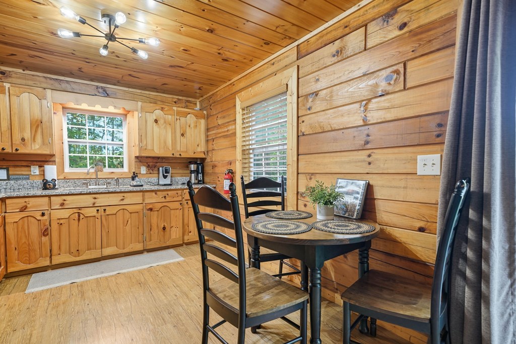 25 Foster Lane Morganton, GA 30560 - Photo 14 of 28 a kitchen with granite countertop a table chairs stove and cabinets