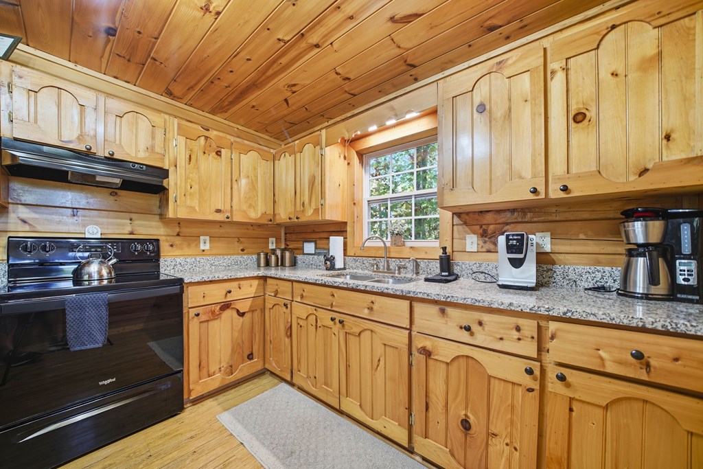 25 Foster Lane Morganton, GA 30560 - Photo 15 of 28 a kitchen with granite countertop cabinets stainless steel appliances a sink and window