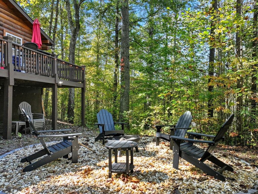 25 Foster Lane Morganton, GA 30560 - Photo 2 of 28 a backyard of a house with barbeque oven table and chairs