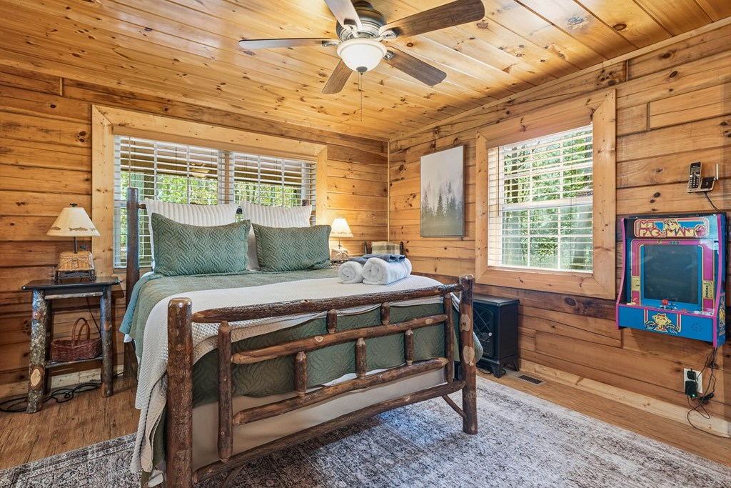 25 Foster Lane Morganton, GA 30560 - Photo 21 of 28 a bedroom with a bed table chair and a flat screen tv