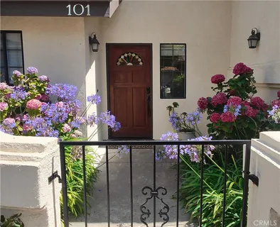 a dining room with furniture a chandelier and wooden floor