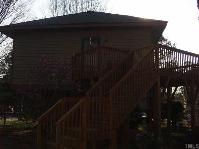 3519 Mill Run Raleigh, NC 27612 - Photo 1 of 6 a black house with trees in front of it