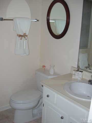 3519 Mill Run Raleigh, NC 27612 - Photo 3 of 6 a bathroom with a sink mirror and toilet