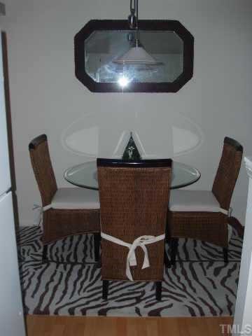3519 Mill Run Raleigh, NC 27612 - Photo 4 of 6 a table chair sitting in a kitchen next to a sink