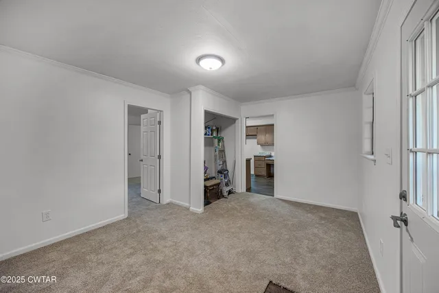 an empty room with closet and a window