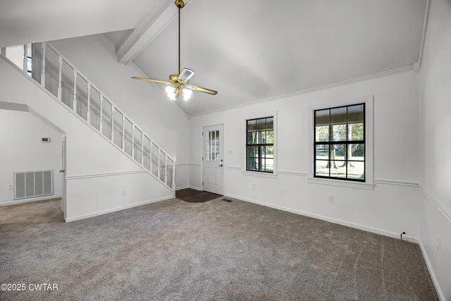 a view of an empty room with a window