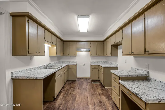 a kitchen with granite countertop stainless steel appliances window a sink and cabinets