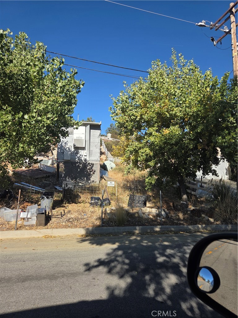 a backyard of a house with table and chairs under an umbrella