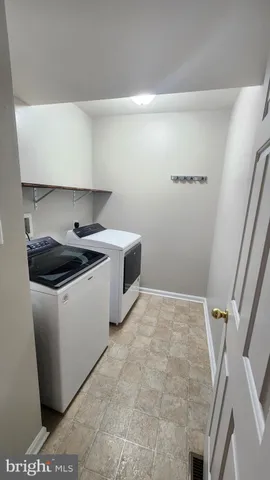 a utility room with sink dryer and washer