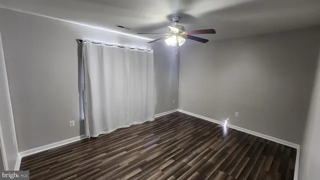 a view of a room with wooden floor