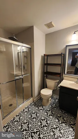 a bathroom with a toilet a sink and a shower