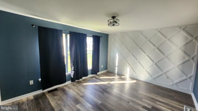 a view of a livingroom with wooden floor and a sliding door