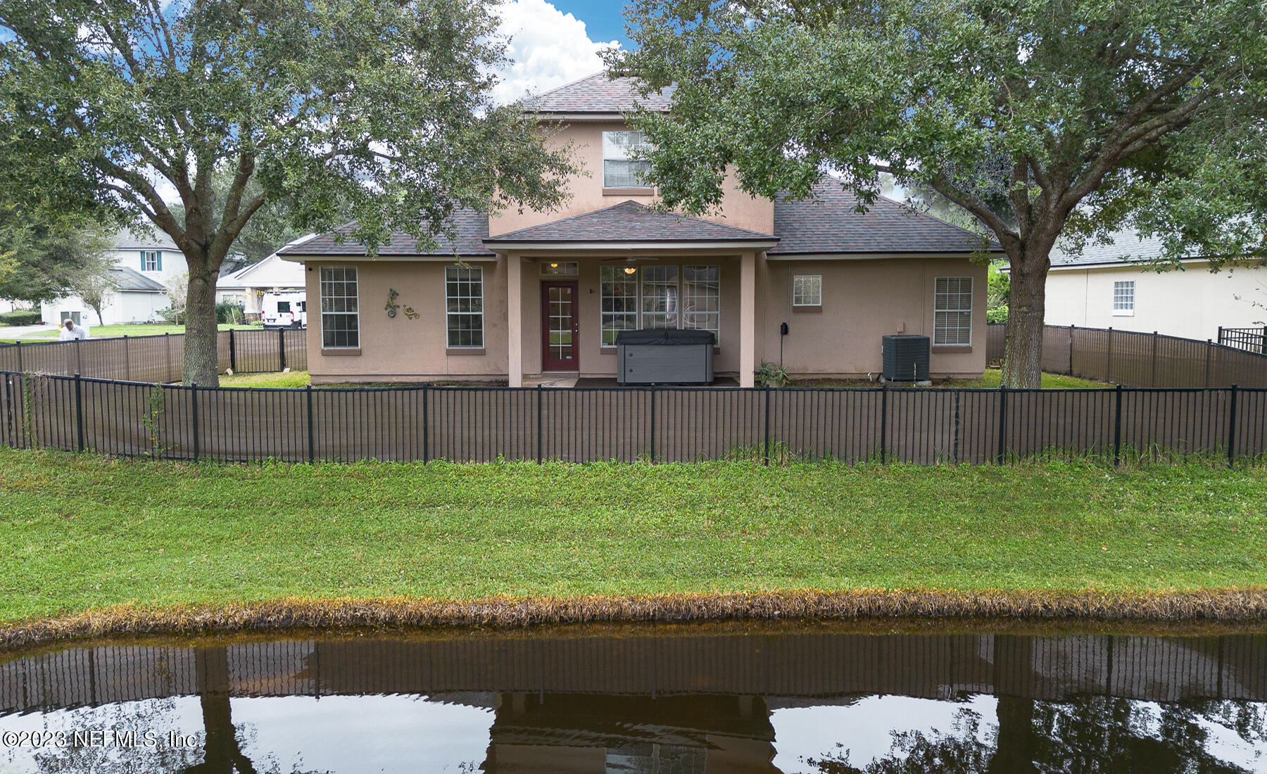 132 Summerhill Circle St. Augustine, FL 32086 - Photo 14 of 35 a front view of a house with a yard and a large tree