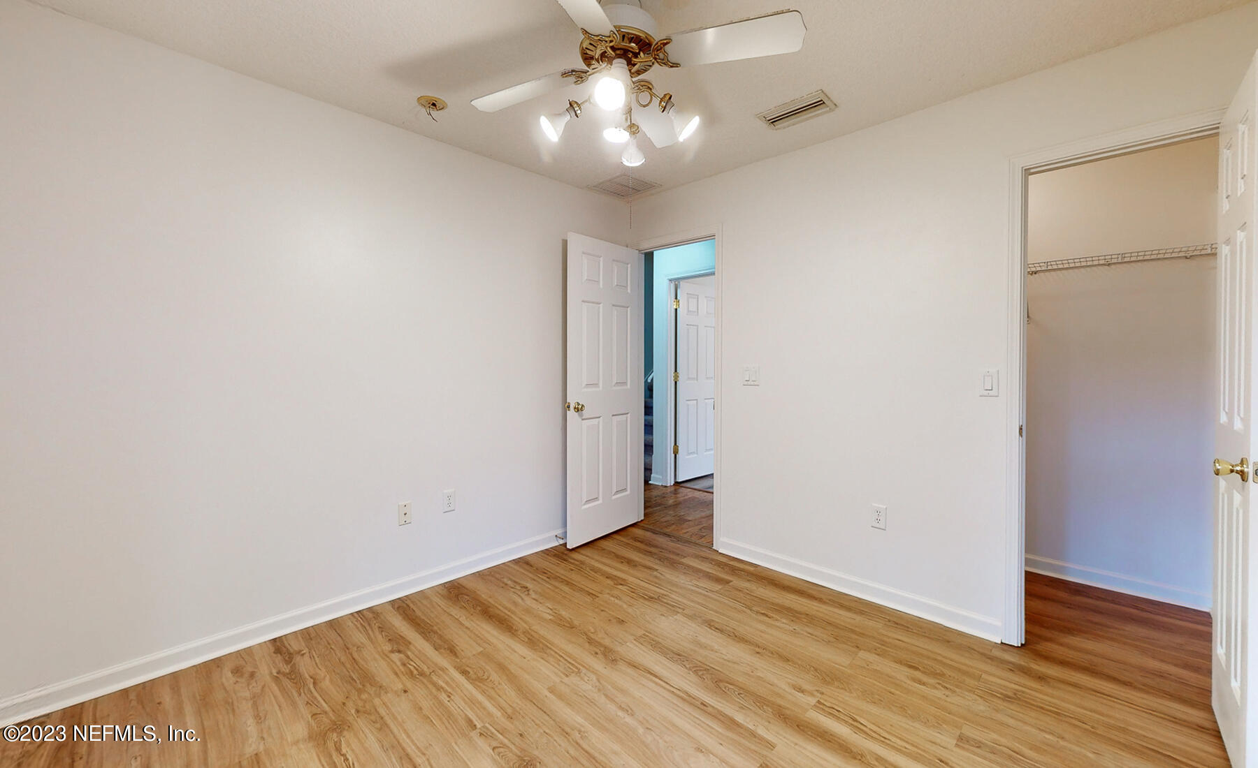 132 Summerhill Circle St. Augustine, FL 32086 - Photo 18 of 35 an empty room with wooden floor and ceiling fan
