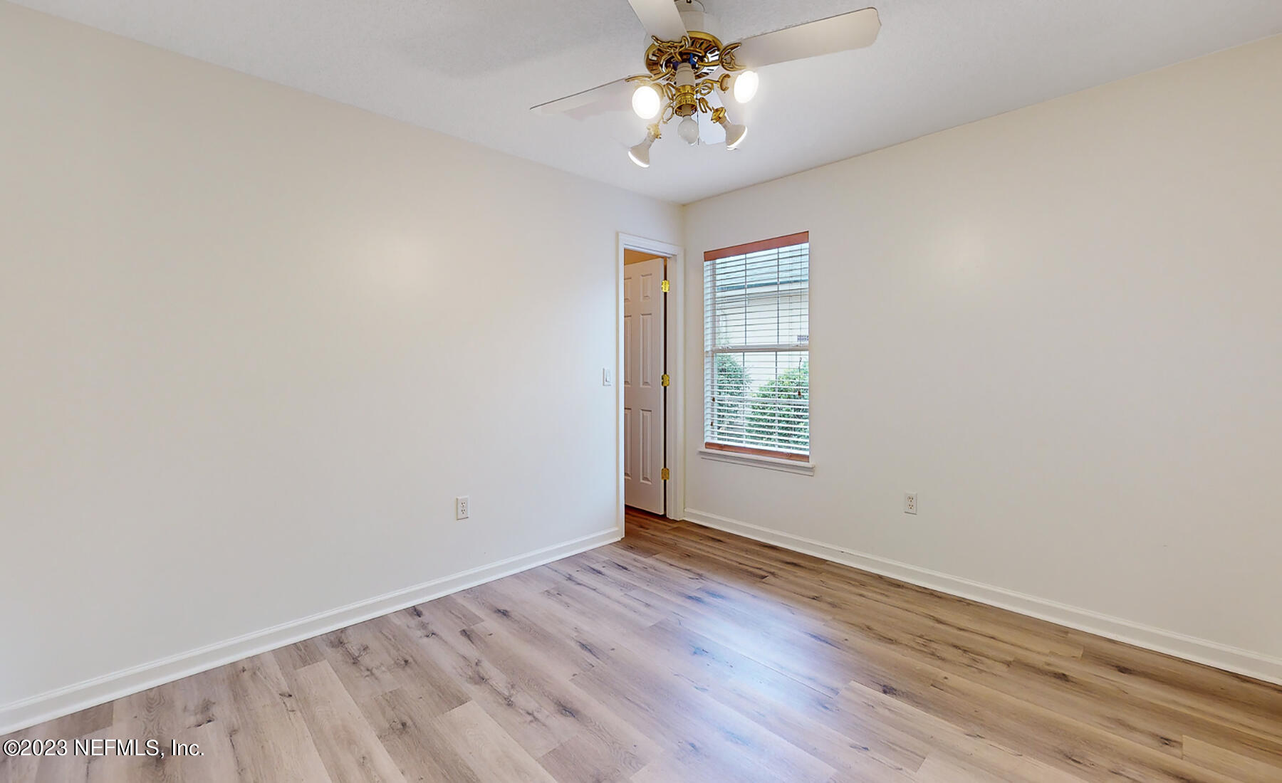 132 Summerhill Circle St. Augustine, FL 32086 - Photo 19 of 35 an empty room with wooden floor chandelier fan and windows