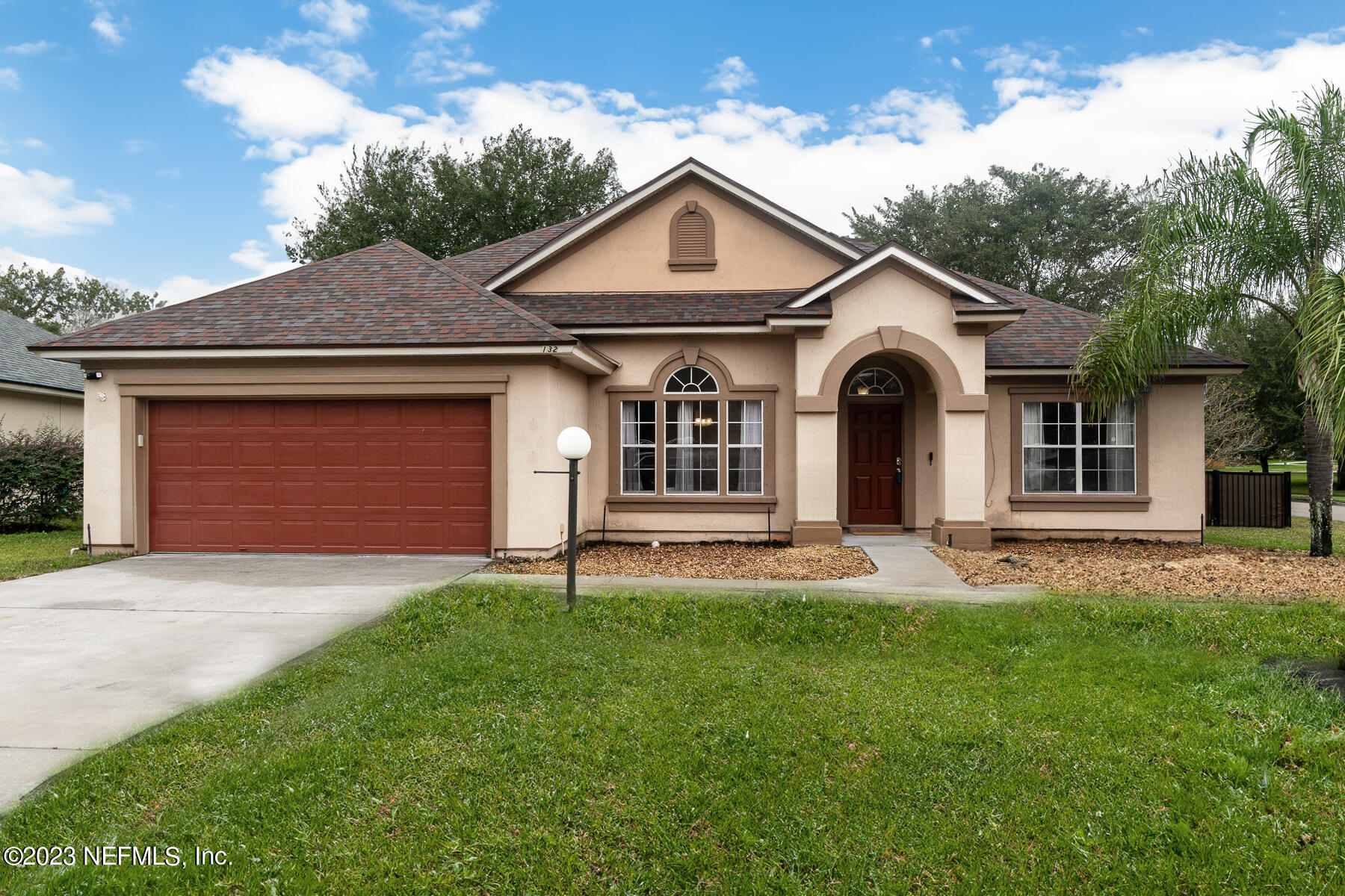 132 Summerhill Circle St. Augustine, FL 32086 - Photo 2 of 35 a front view of a house with a yard and garage