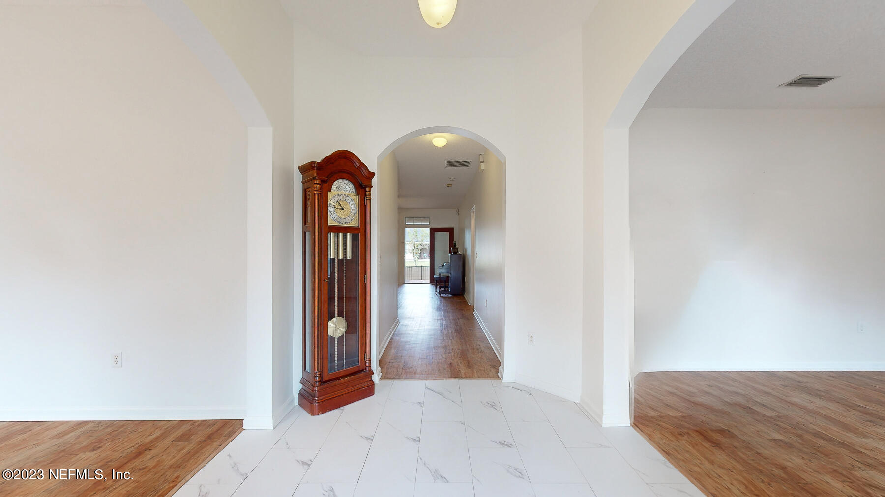 132 Summerhill Circle St. Augustine, FL 32086 - Photo 4 of 35 a view of a hallway view with wooden floor and staircase