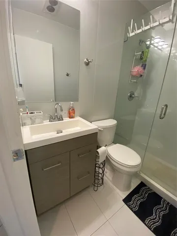 a bathroom with a sink mirror vanity and toilet