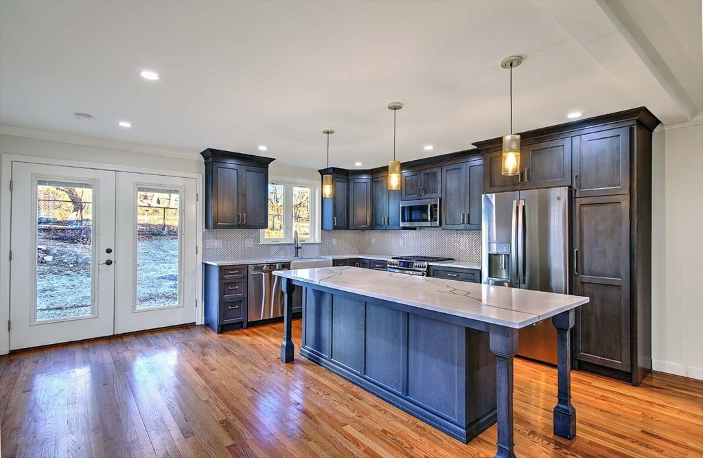 3 Wensley Street, Unit 1 Boston, MA 02120 - Photo 11 of 40 a kitchen with stainless steel appliances granite countertop a refrigerator a stove and a wooden floors