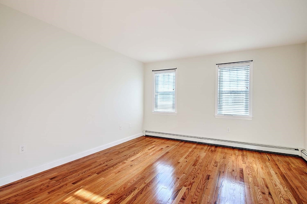 3 Wensley Street, Unit 1 Boston, MA 02120 - Photo 20 of 40 an empty room with wooden floor and windows