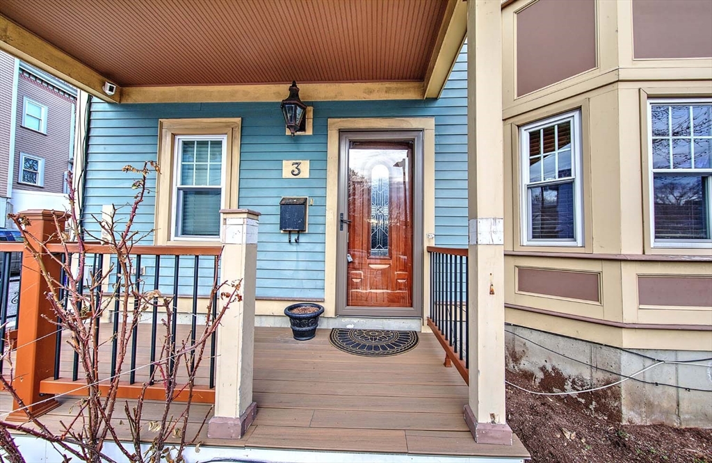 3 Wensley Street, Unit 1 Boston, MA 02120 - Photo 2 of 40 a view of a house with large windows and a small yard