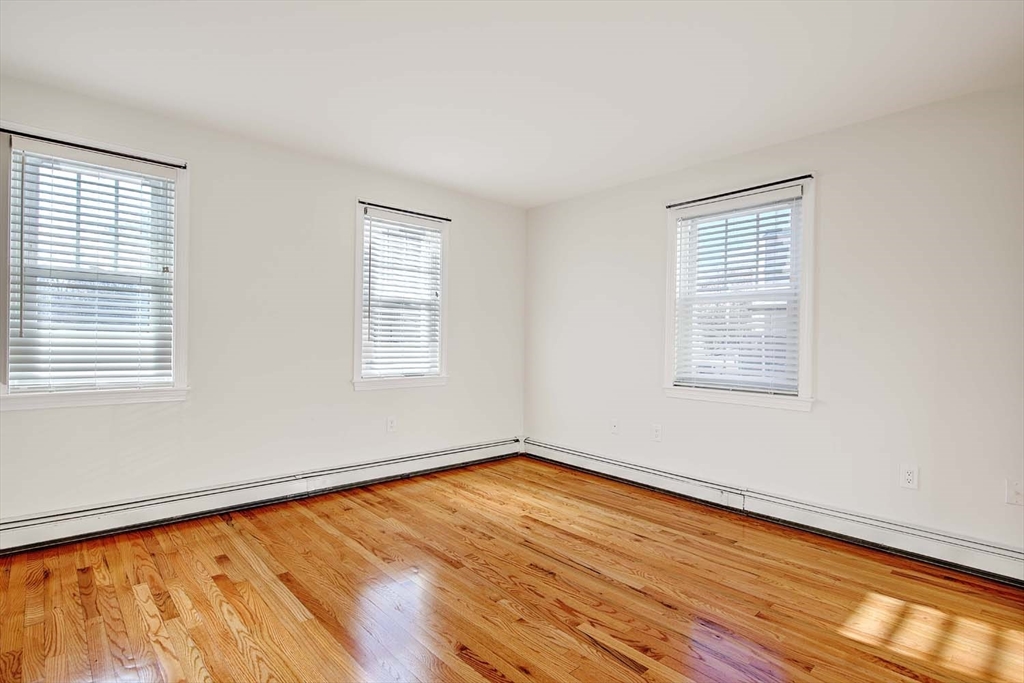 3 Wensley Street, Unit 1 Boston, MA 02120 - Photo 21 of 40 a view of empty room with wooden floor and fan