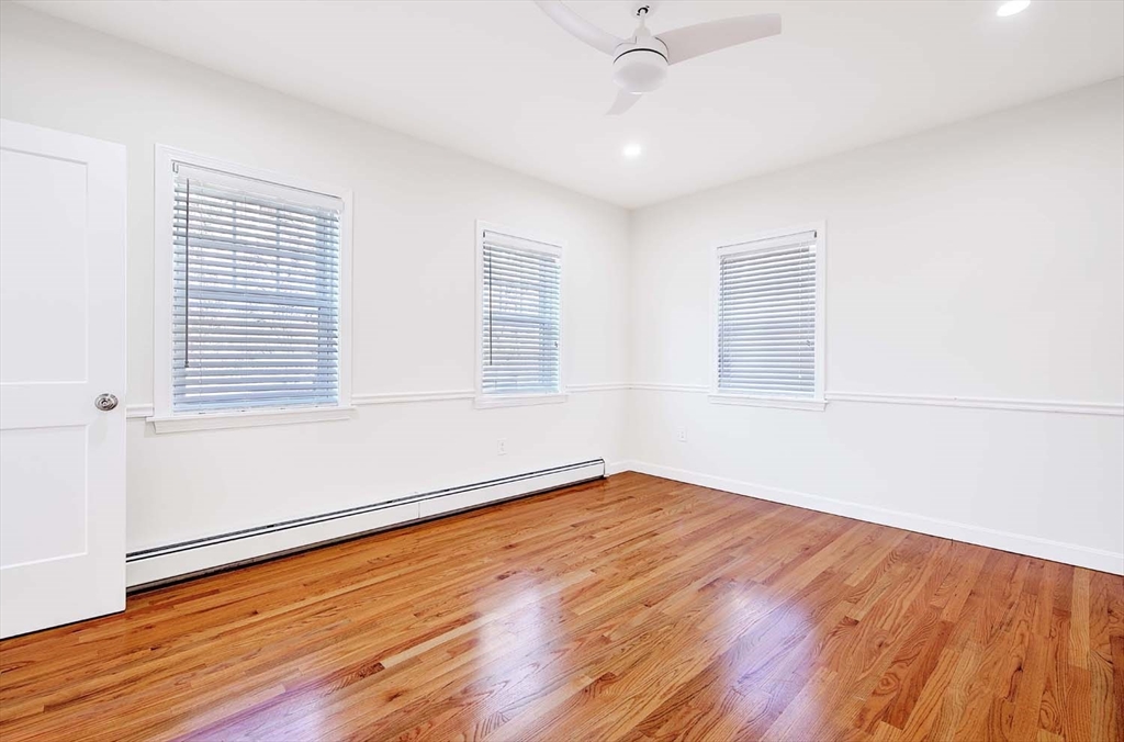 3 Wensley Street, Unit 1 Boston, MA 02120 - Photo 25 of 40 an empty room with wooden floor and windows