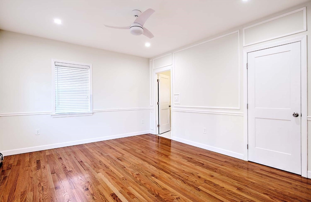 3 Wensley Street, Unit 1 Boston, MA 02120 - Photo 26 of 40 an empty room with wooden floor and windows