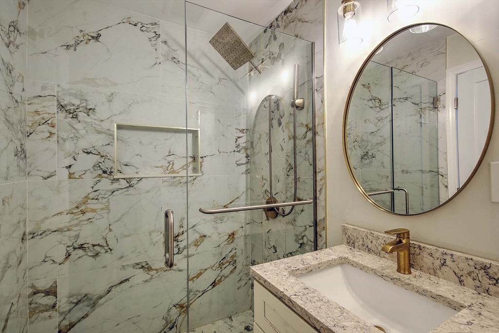 3 Wensley Street, Unit 1 Boston, MA 02120 - Photo 35 of 40 a bathroom with a granite countertop sink a mirror and shower