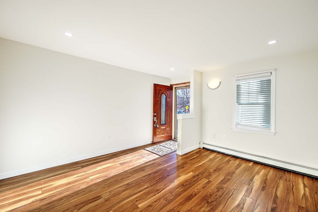 3 Wensley Street, Unit 1 Boston, MA 02120 - Photo 6 of 40 a view of an empty room with wooden floor and a window