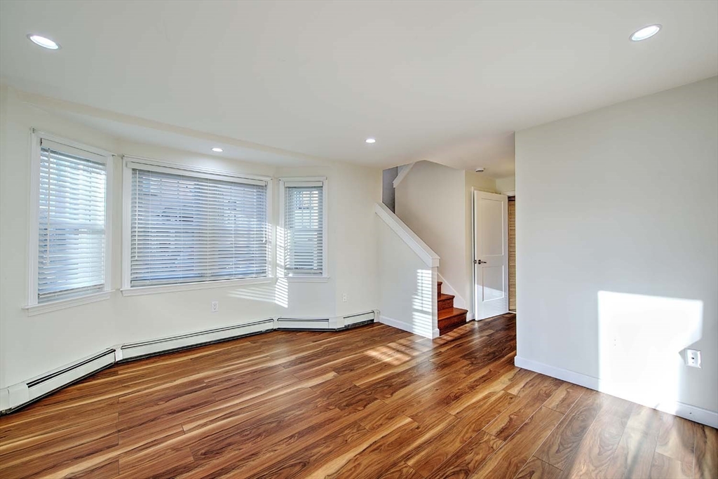 3 Wensley Street, Unit 1 Boston, MA 02120 - Photo 7 of 40 an empty room with wooden floor and windows