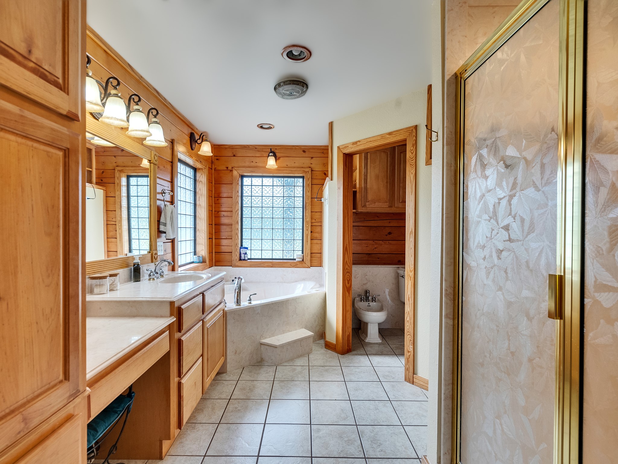 325 Forest Service 217 Road Shepherd, TX 77371 - Photo 36 of 46 a spacious bathroom with a granite countertop tub and a large window