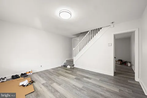a view of a room with wooden floor and stairs