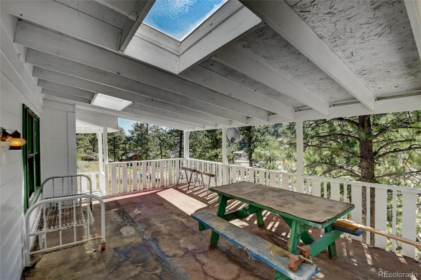 101 Main Street Bailey, CO 80421 - Photo 16 of 22 a balcony with furniture and a swing