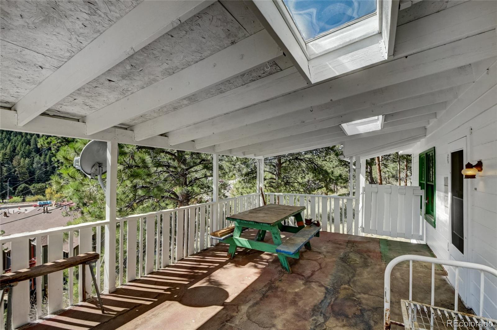 101 Main Street Bailey, CO 80421 - Photo 17 of 22 a balcony with furniture and potted plants