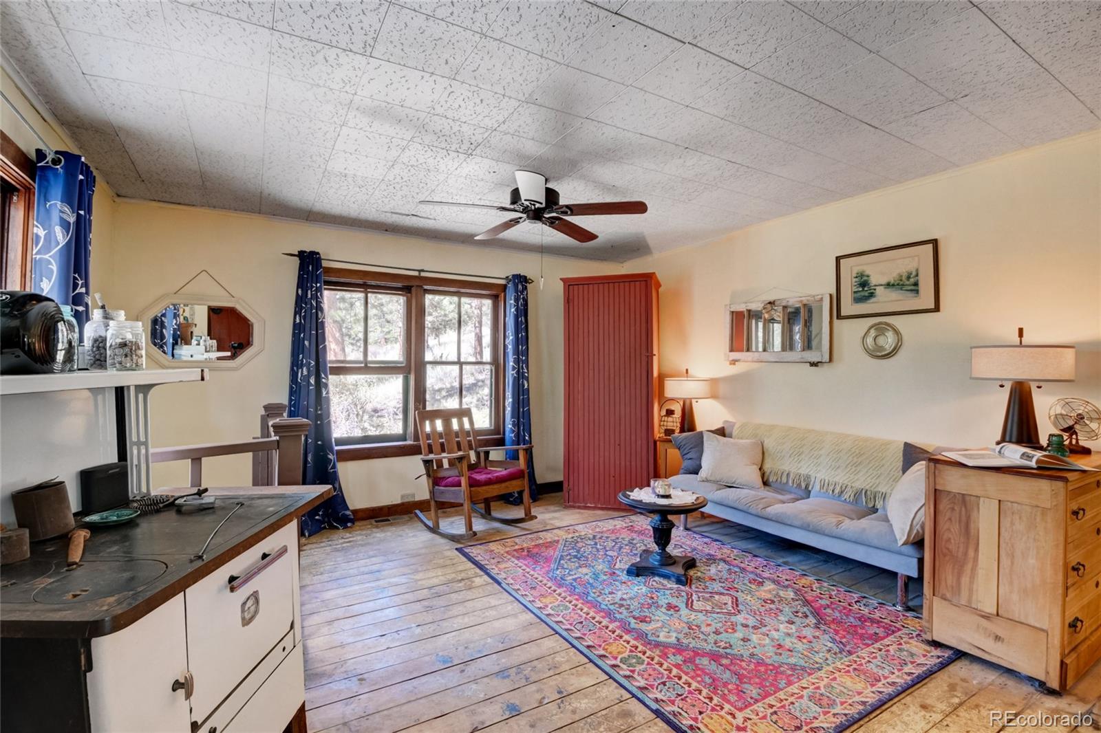 101 Main Street Bailey, CO 80421 - Photo 7 of 22 a living room with furniture a rug and a chandelier