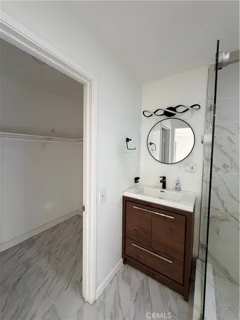 a bathroom with a sink a mirror and a vanity