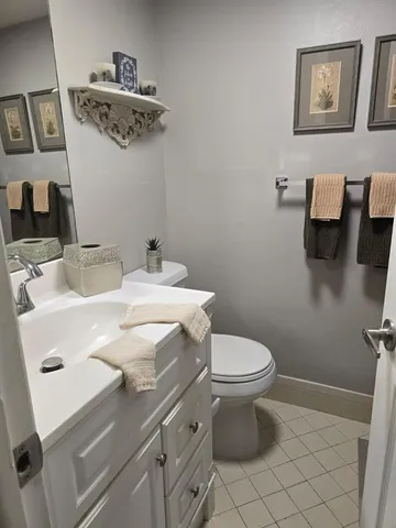 a bathroom with a sink toilet and a mirror